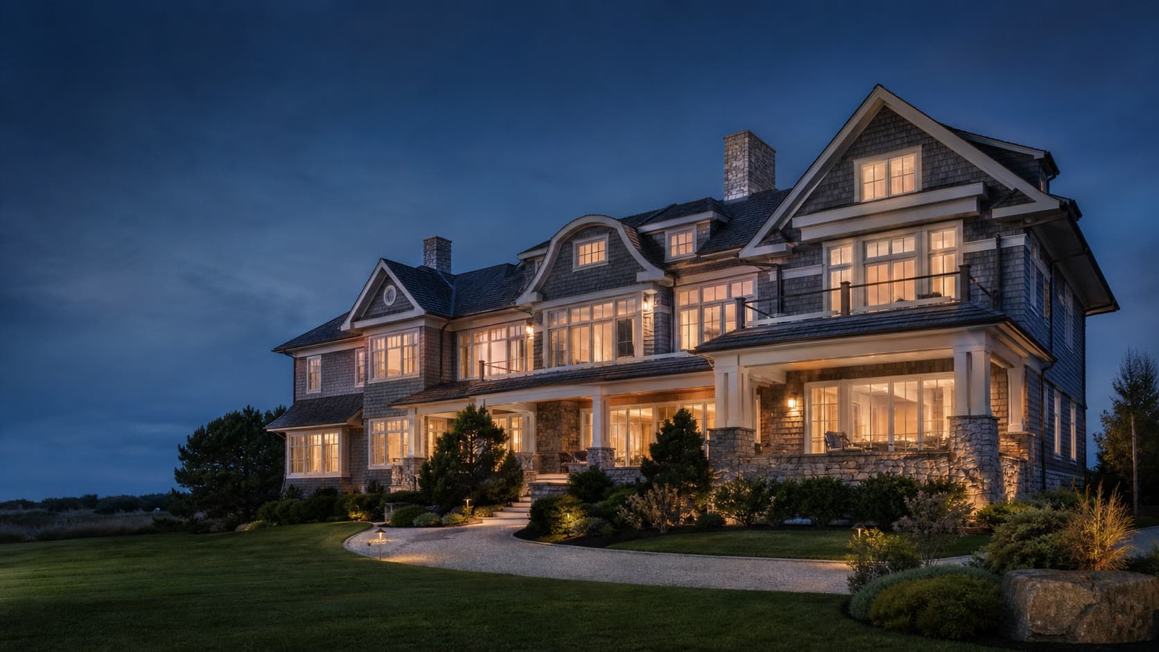 Grand coastal estate illuminated at blue hour
